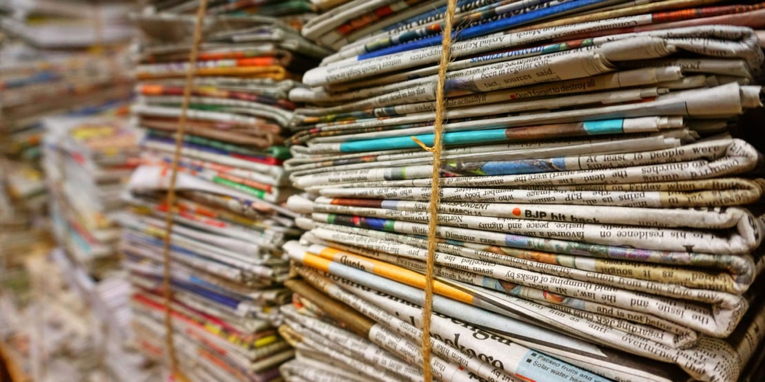 Stacks of newspapers tied with string