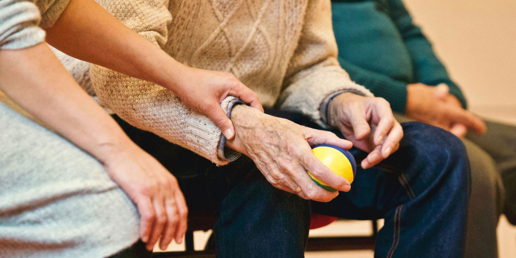 Elderly man's hands holding a stress relief ball